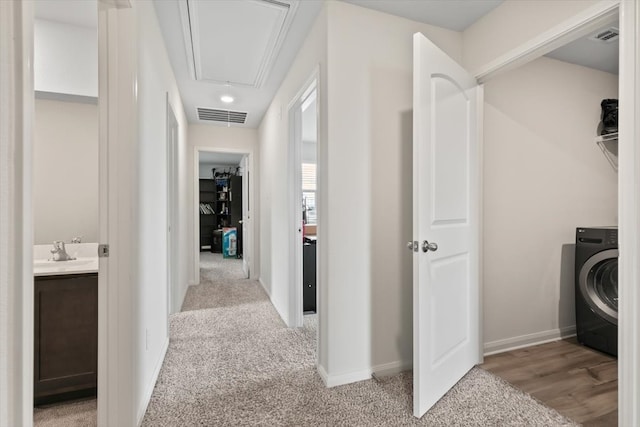 washroom featuring light hardwood / wood-style flooring and washer / clothes dryer