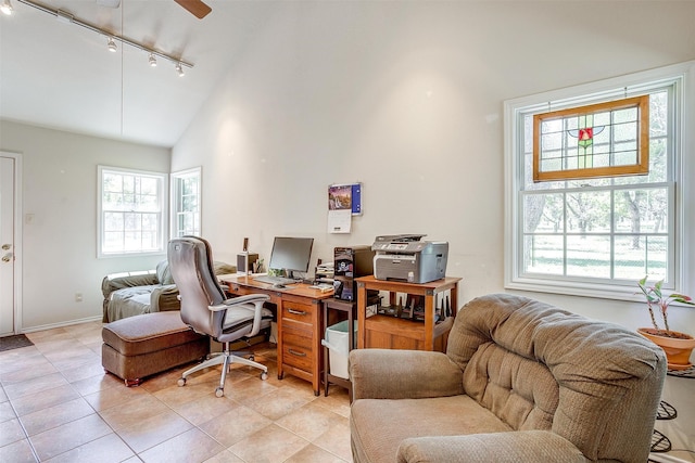 tiled office space featuring high vaulted ceiling, rail lighting, ceiling fan, and a wealth of natural light