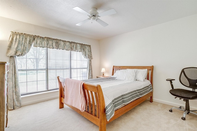 carpeted bedroom with a textured ceiling and ceiling fan