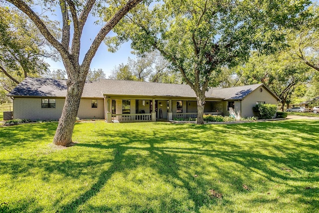 rear view of property featuring a yard, covered porch, and central air condition unit