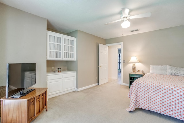 bedroom featuring ceiling fan and light carpet