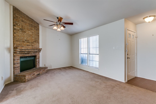 unfurnished living room with carpet flooring, ceiling fan, and a fireplace