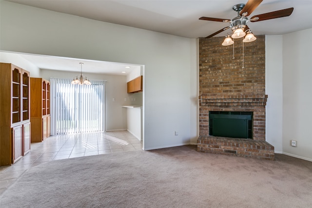 unfurnished living room with light colored carpet, ceiling fan with notable chandelier, and a brick fireplace