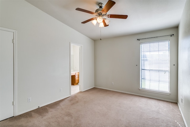 carpeted empty room with lofted ceiling and ceiling fan