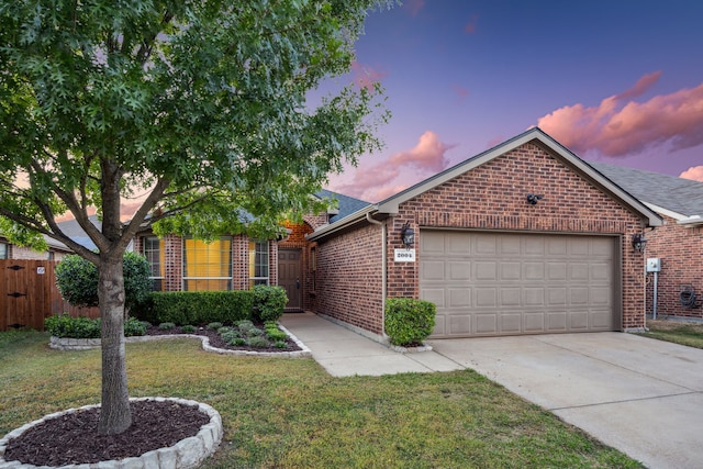 view of front facade with a garage and a yard