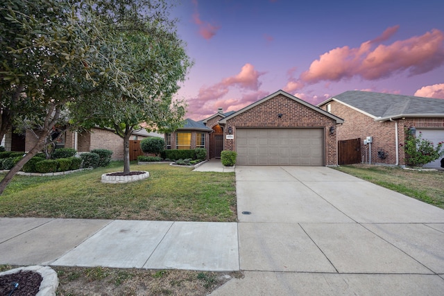 single story home with a garage and a lawn