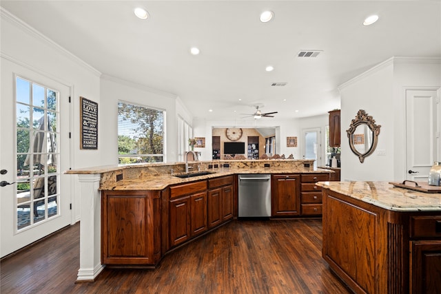 kitchen with a large island, dishwasher, light stone countertops, and sink