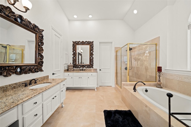 bathroom featuring tile patterned floors, vanity, separate shower and tub, and lofted ceiling