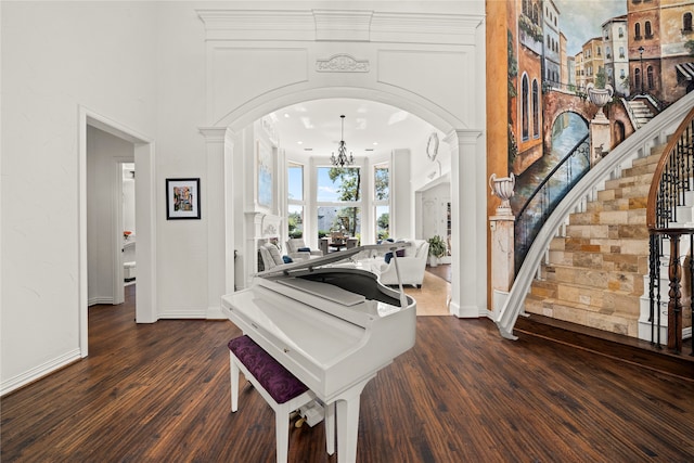 foyer entrance with dark hardwood / wood-style floors and a notable chandelier