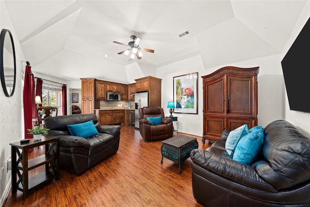 living room with ceiling fan, wood-type flooring, and lofted ceiling