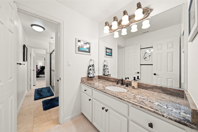 bathroom with tile patterned floors and vanity