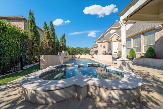 view of pool with an in ground hot tub and a patio area