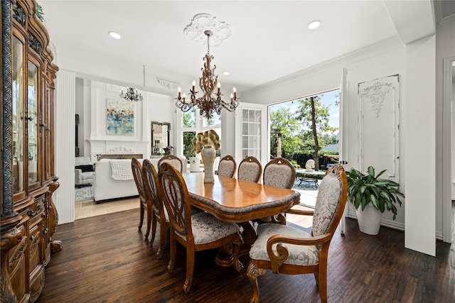 dining space with a notable chandelier, dark hardwood / wood-style floors, and ornamental molding