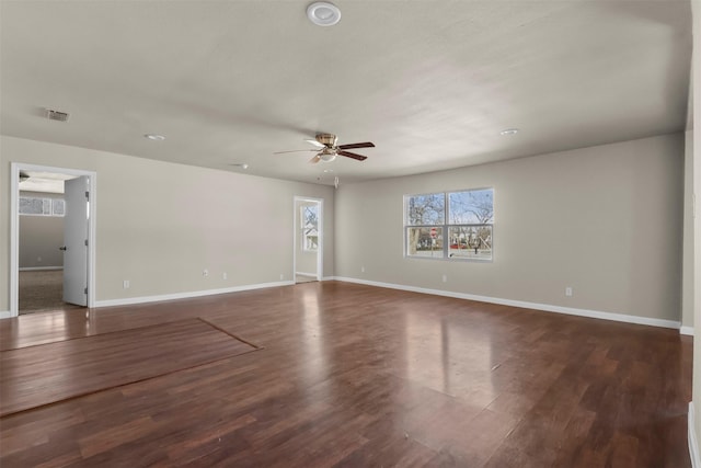 empty room featuring ceiling fan and dark hardwood / wood-style flooring