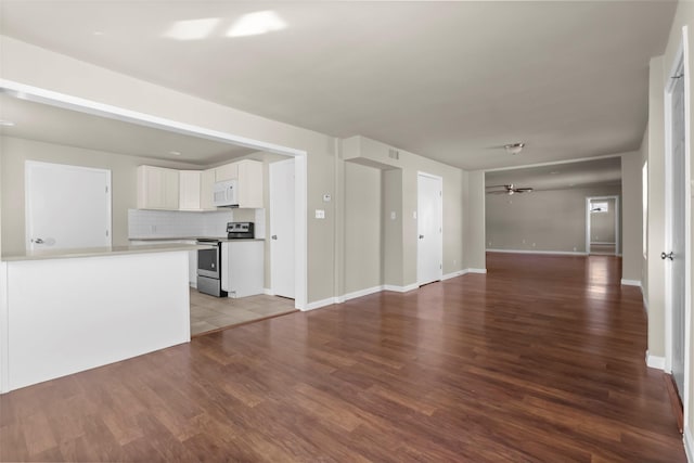 unfurnished living room featuring hardwood / wood-style floors and ceiling fan