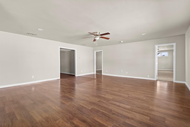 spare room featuring ceiling fan and dark hardwood / wood-style flooring