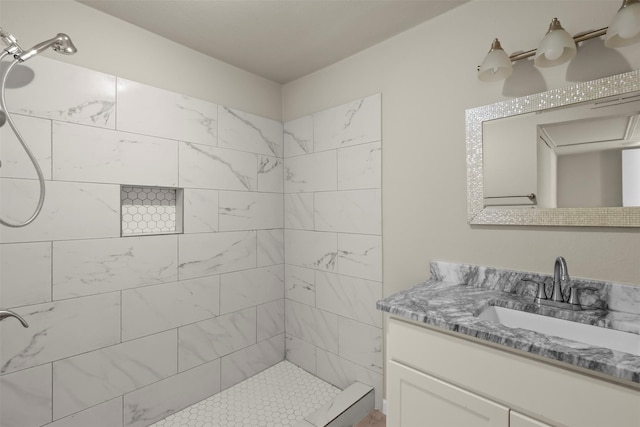 bathroom featuring vanity and a tile shower