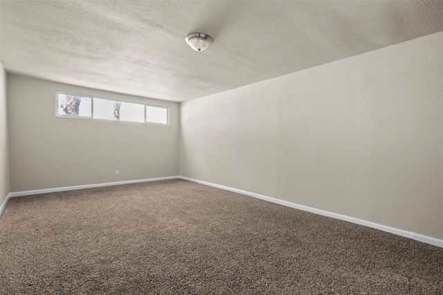 spare room with a textured ceiling and carpet flooring