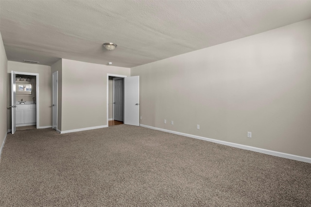 unfurnished bedroom with carpet flooring and a textured ceiling