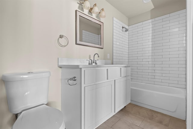 full bathroom with tile patterned flooring, vanity, tiled shower / bath, and toilet