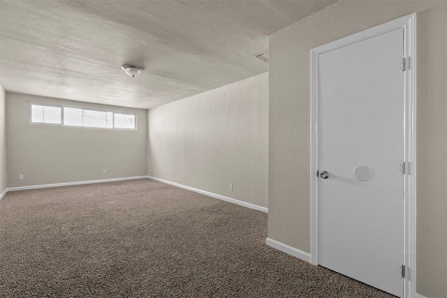 carpeted spare room featuring a textured ceiling