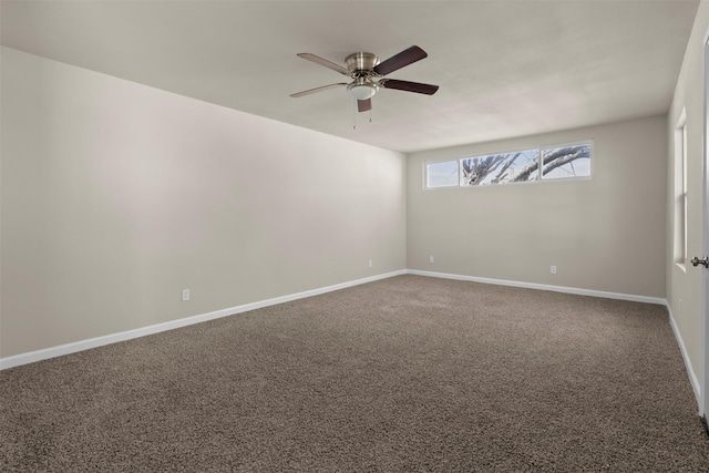 carpeted empty room featuring ceiling fan