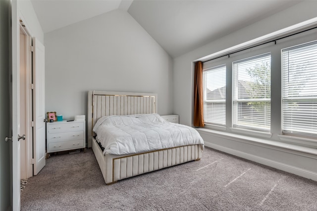 bedroom featuring lofted ceiling and carpet flooring