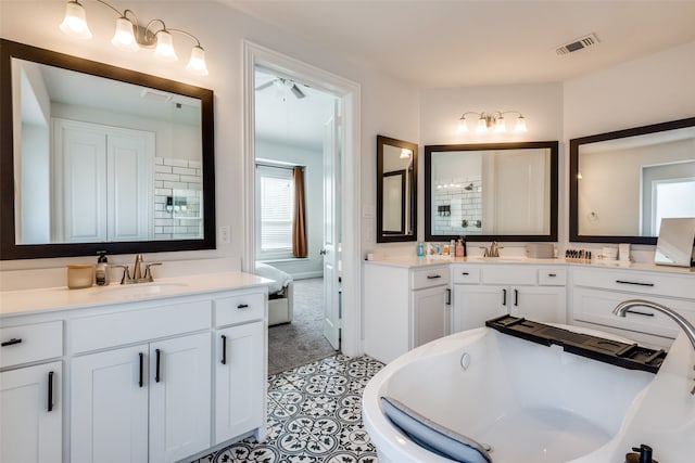 bathroom with vanity, tile patterned floors, and a washtub