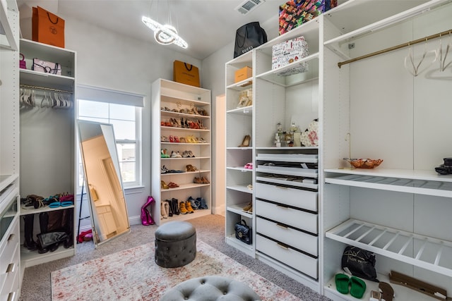 walk in closet featuring carpet flooring