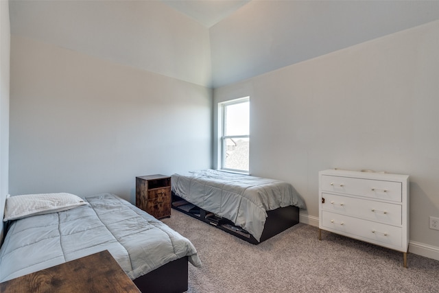 carpeted bedroom with lofted ceiling