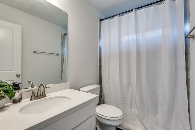 bathroom with vanity, toilet, and a shower with shower curtain