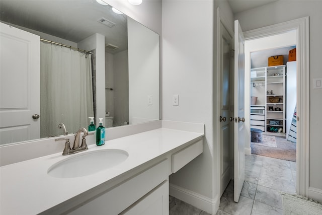 bathroom with vanity and toilet