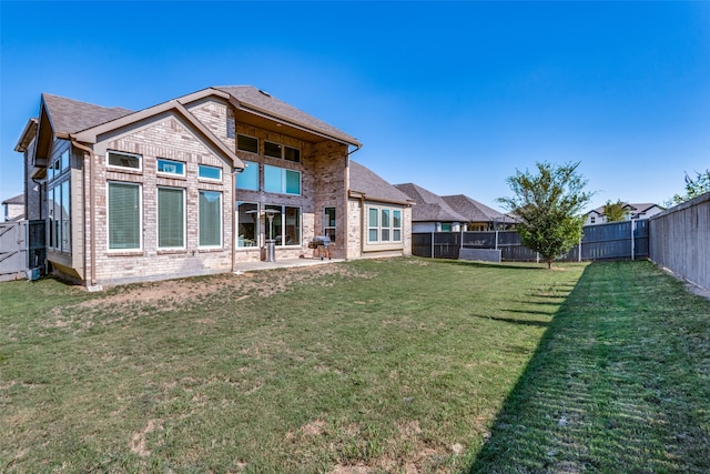 back of house featuring a yard and a patio area