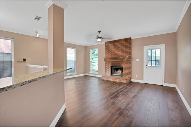 unfurnished living room featuring plenty of natural light, ceiling fan, and dark hardwood / wood-style floors