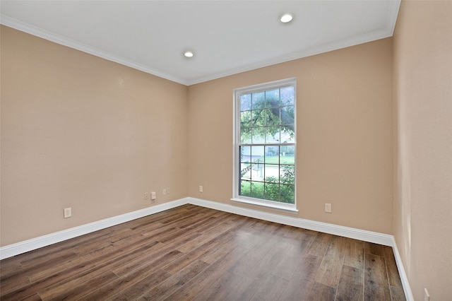 empty room featuring ornamental molding and hardwood / wood-style flooring