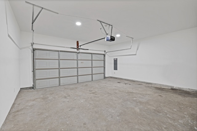 garage with a garage door opener and electric panel