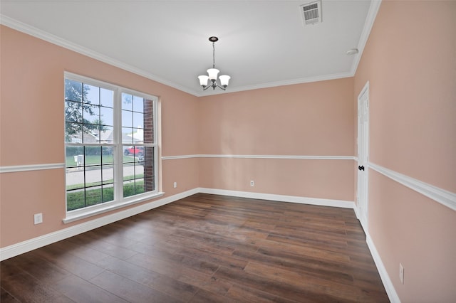 empty room with a notable chandelier, dark hardwood / wood-style floors, and ornamental molding