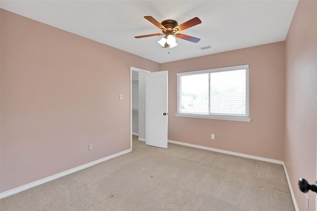 unfurnished bedroom with light carpet and ceiling fan