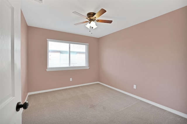 empty room with ceiling fan and light colored carpet