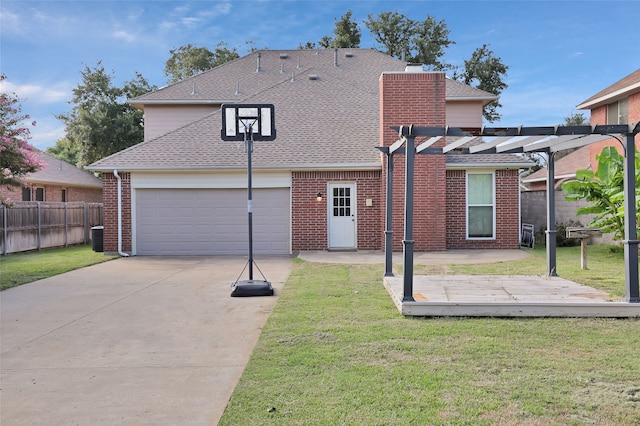 rear view of house with a lawn, a pergola, and a garage