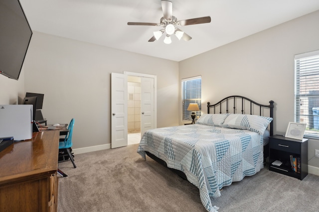 carpeted bedroom with ceiling fan and connected bathroom