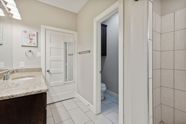 bathroom with tile patterned floors, toilet, and vanity