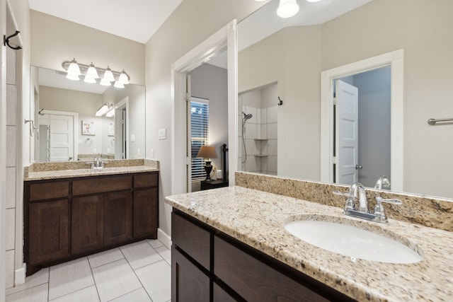 bathroom featuring vanity, a shower, and tile patterned flooring