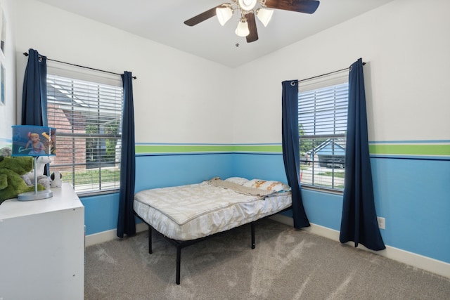 bedroom with ceiling fan and light colored carpet