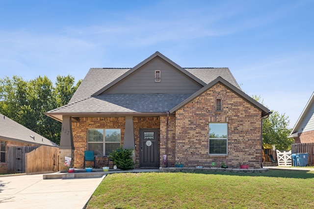 view of front of home with a porch and a front lawn