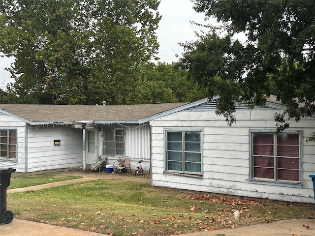 back of house with a lawn