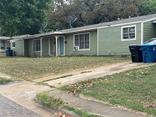 ranch-style house with cooling unit and a front yard