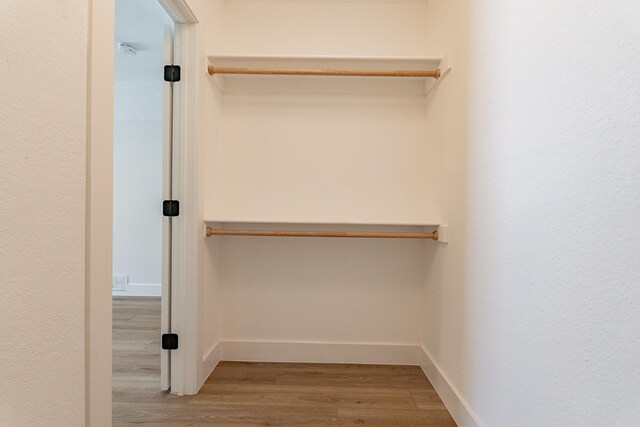 spacious closet featuring light wood-type flooring