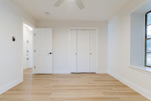 unfurnished bedroom with light hardwood / wood-style flooring, ceiling fan, and multiple windows