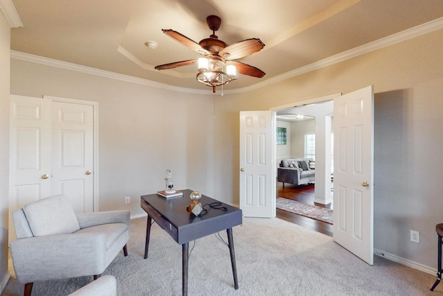 office with a raised ceiling, ceiling fan, ornamental molding, and hardwood / wood-style floors